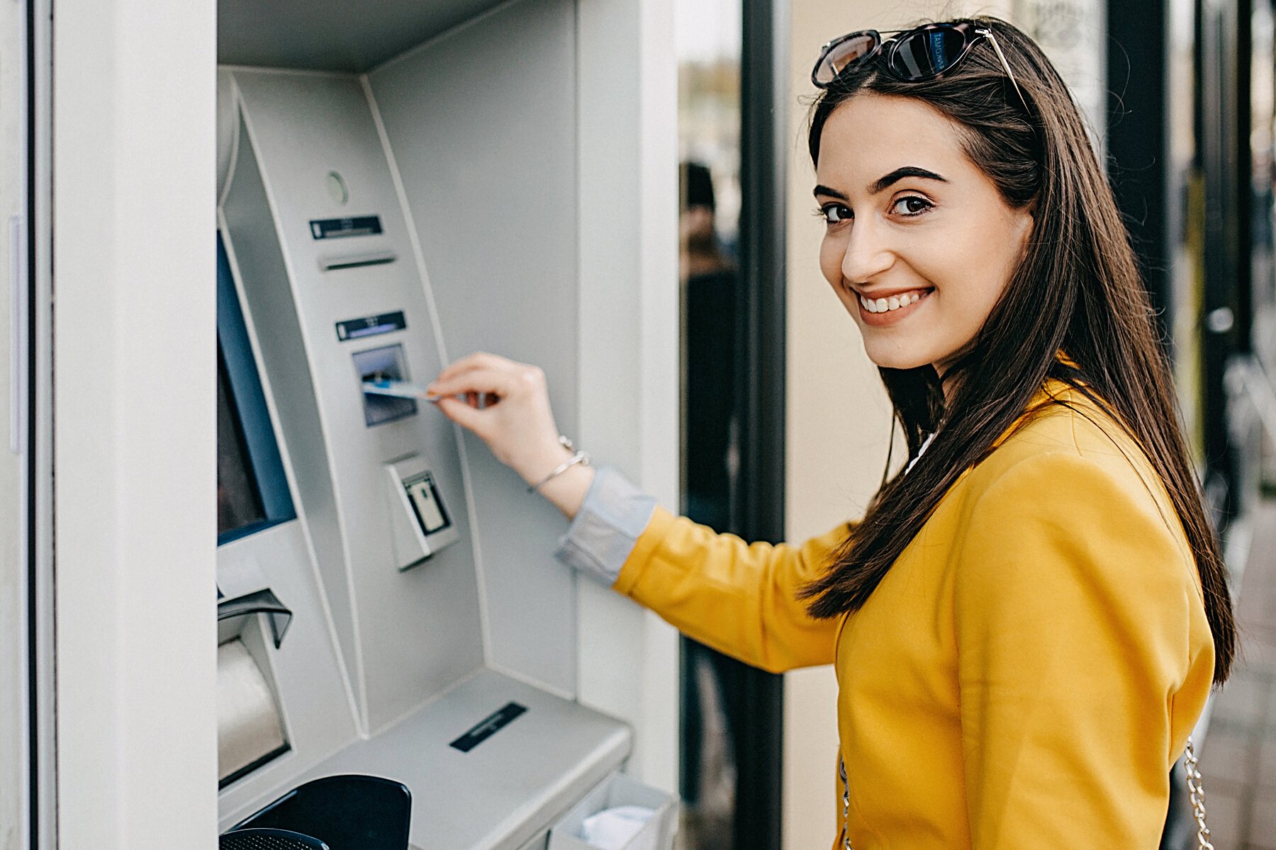 Woman using ATM machine